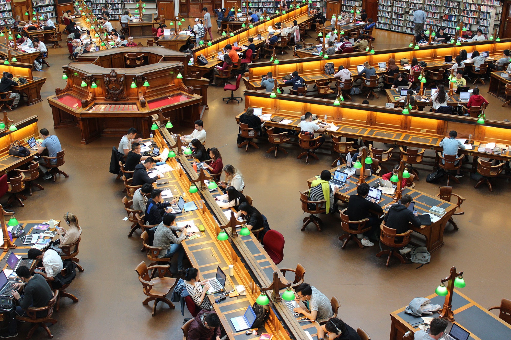 Wide angle view of a library filled with students all studying at their own desks