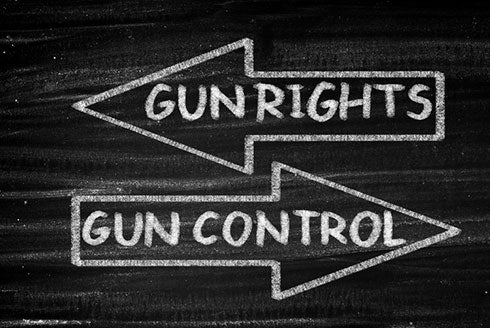 Black chalkboard background with two arrows on top of each other facing in opposite directions, top arrow has text that reads 'Gun Rights', bottom arrow has text that reads 'Gun Control'